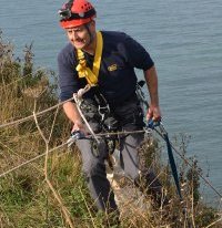 He reaches the cliff top with the injured bird after the dramatic eight-hour rescue