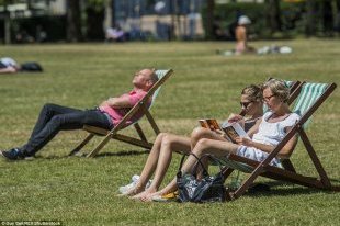 Here comes the sun (again): After Thursday's storms, the sun came out once again today prompting people to flock to Green Park, London