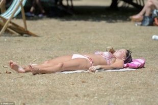 Topping up the tan: Temperatures soared to 30C (86F) across southern parts of the country yesterday. People flocked to parks across the country today (Hyde Park, pictured) to make the most of the weather